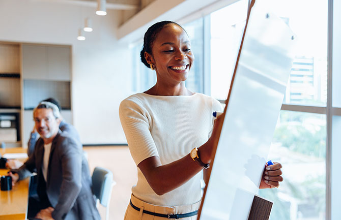 woman writing on whiteboard