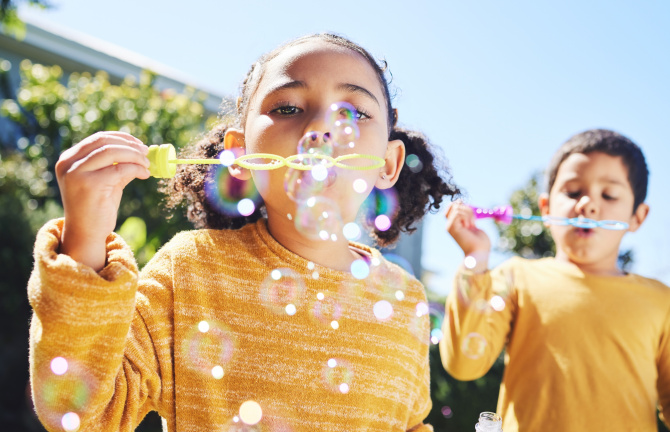 Two children blowing bubbles.