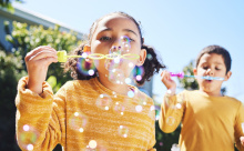 Two children blowing bubbles.