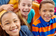 three young children smiling