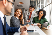 people sitting around a table in an office